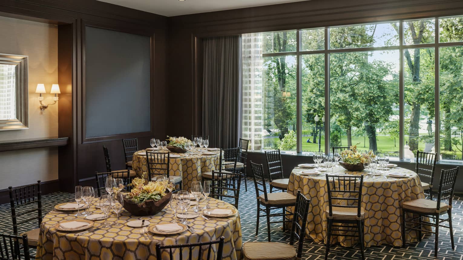 Round tables with patterned linens, large window in Stuart event room