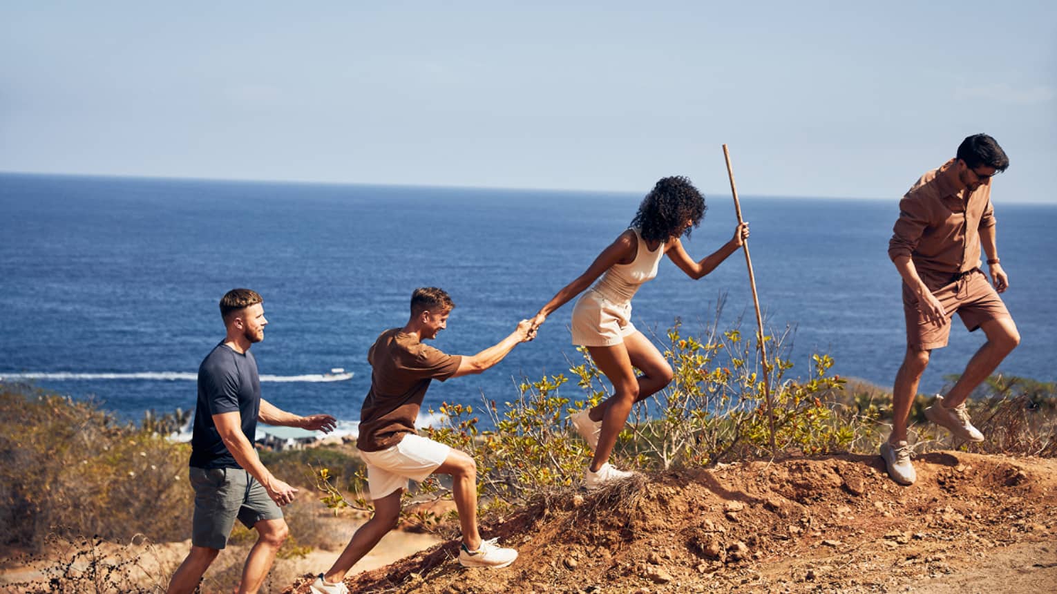 A group of people hiking along a beach.