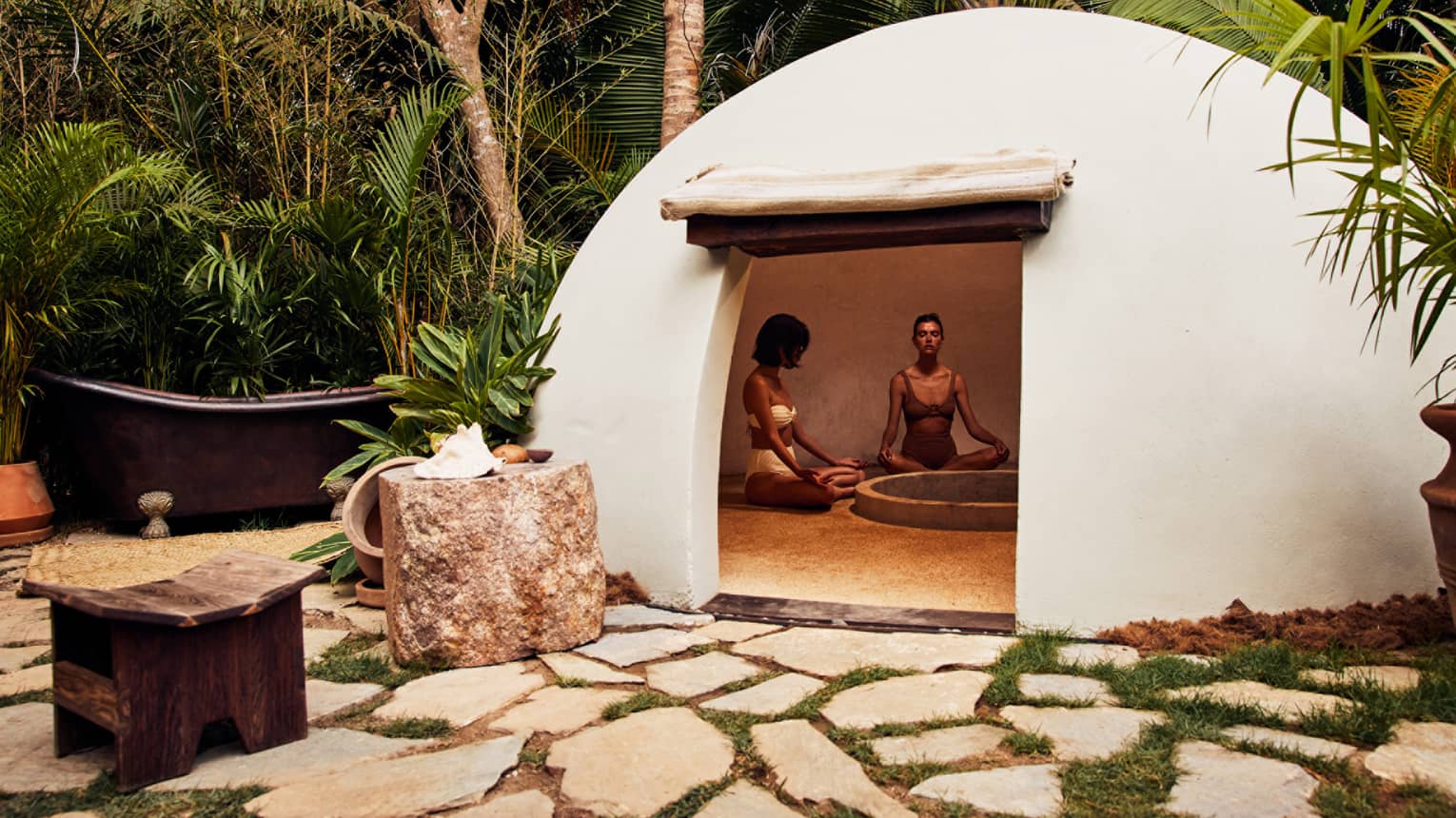 A heated dome shaped room surrounded by trees.