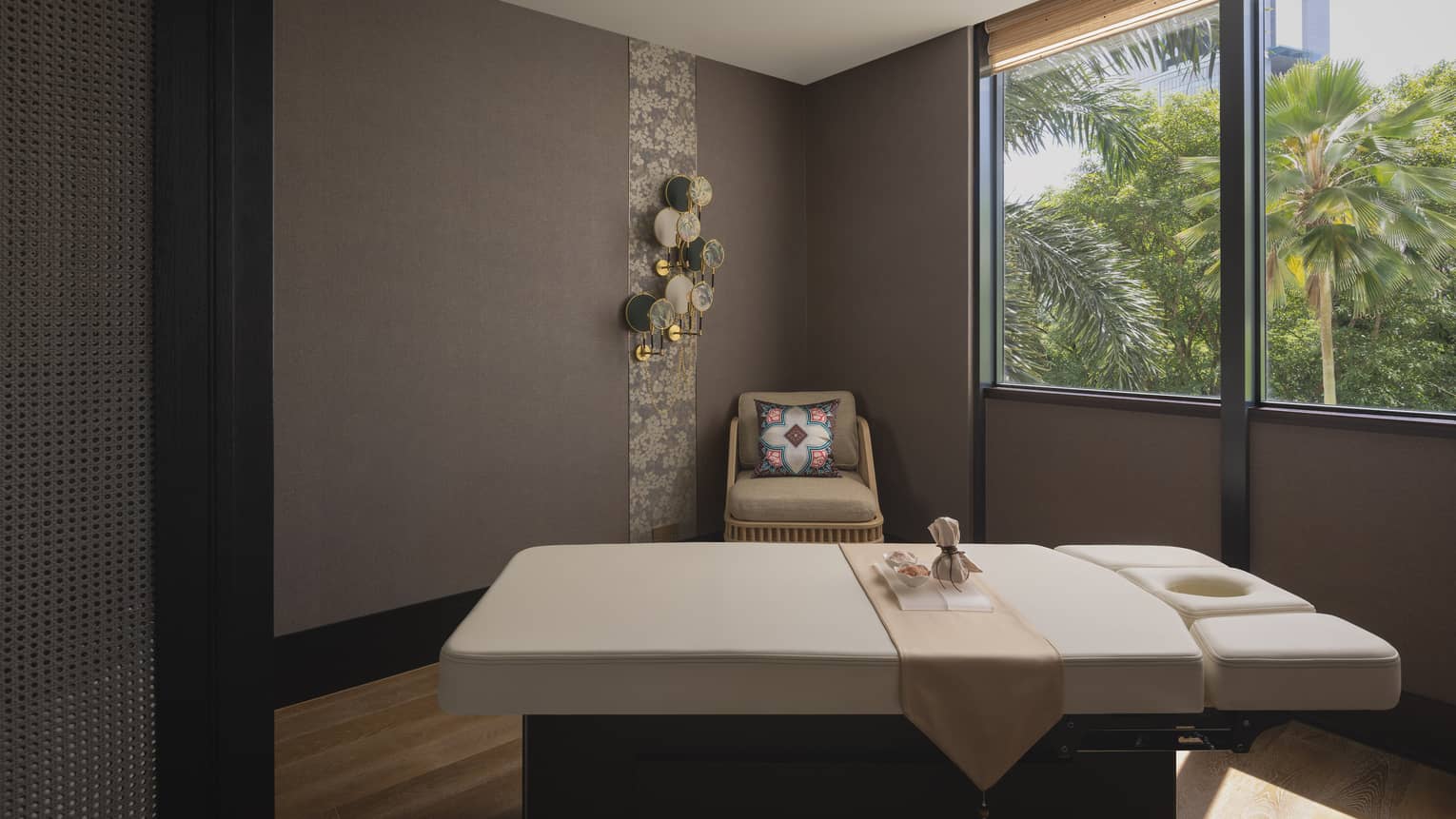 Massage table with a view of the jungle outside the window