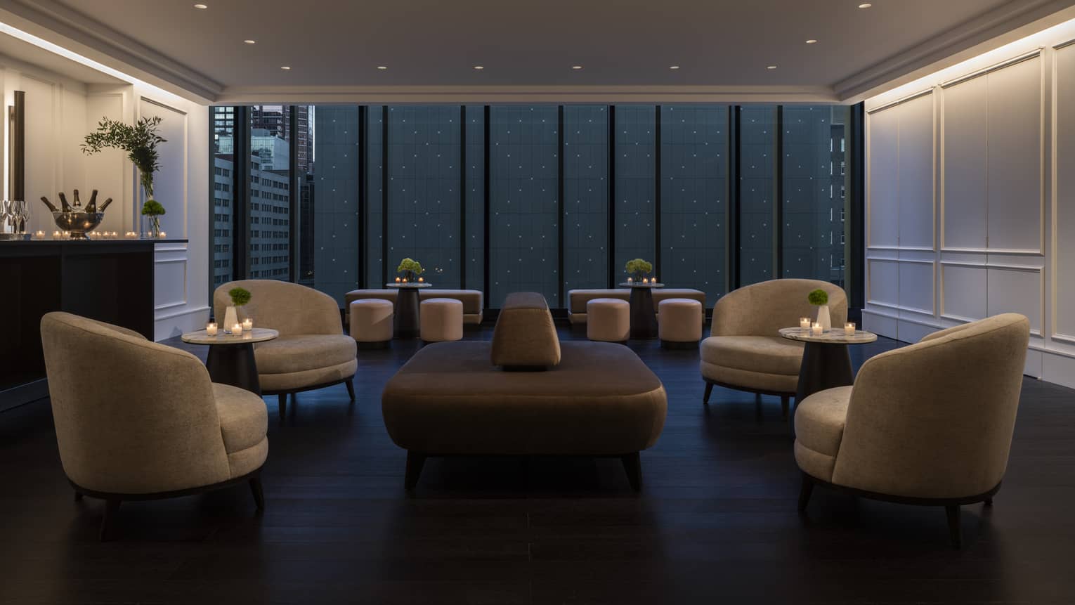 Curved modern club chairs and a central bench fill the dimly lit Hotel foyer