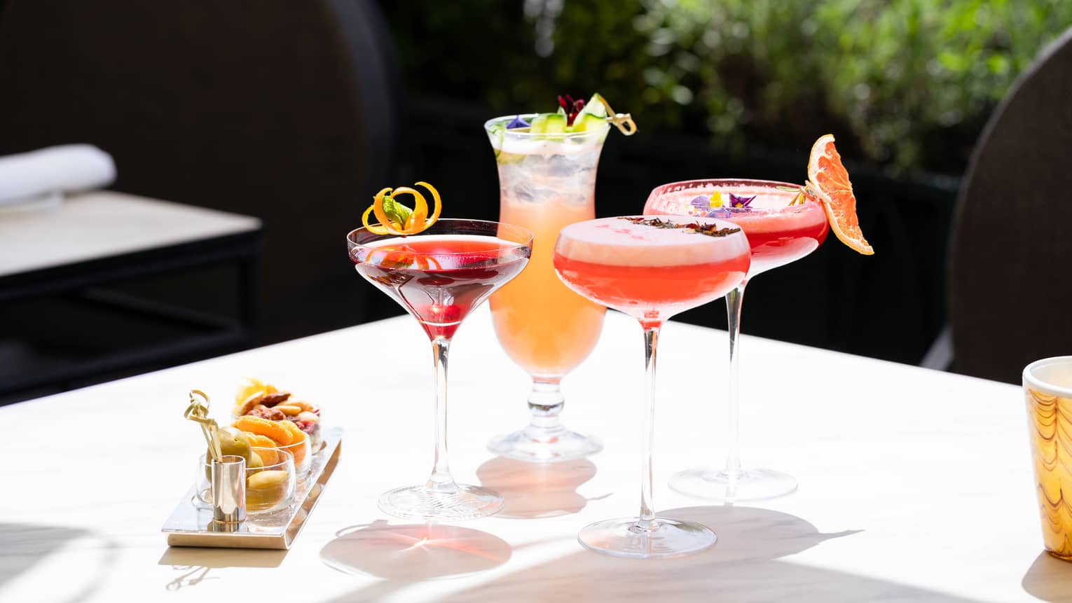 Assorted summer cocktails and bar snacks