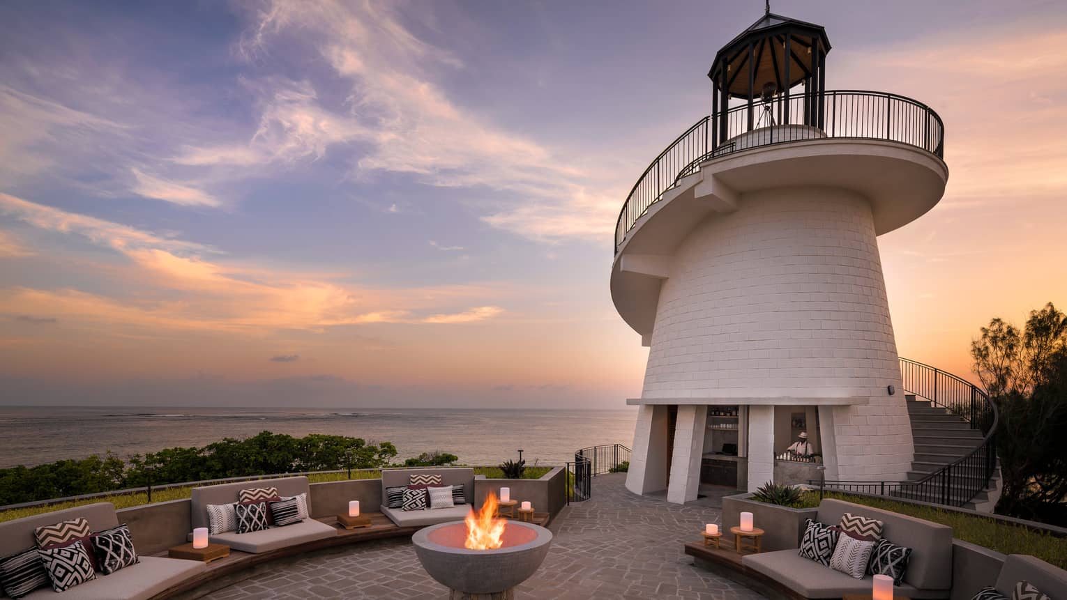 Lighthouse Restaurant illuminated at sunset with fire pit and luminaries