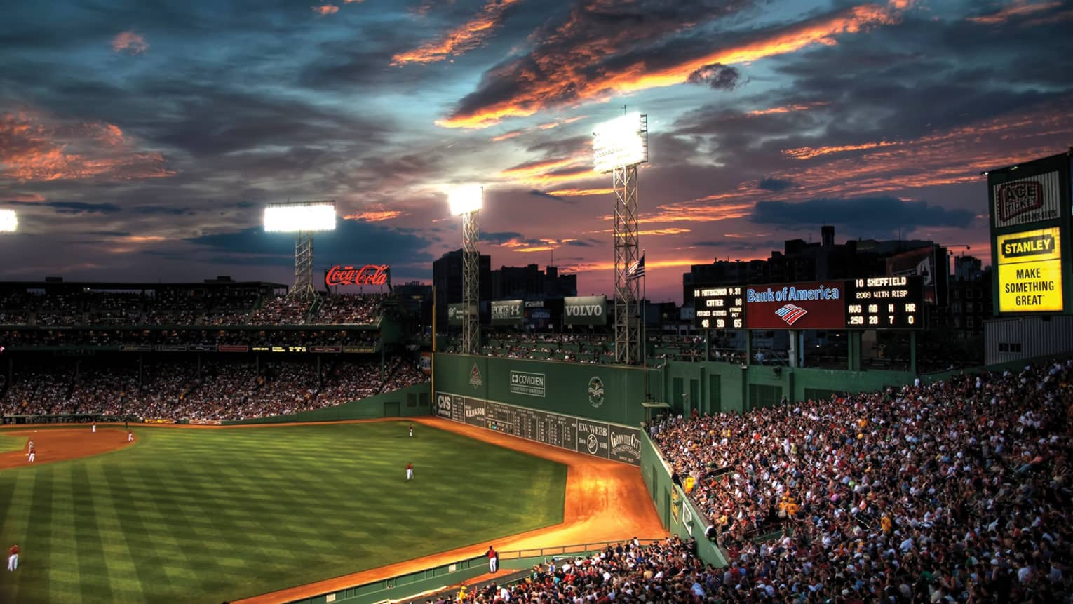 the sun sets over fenway park in boston