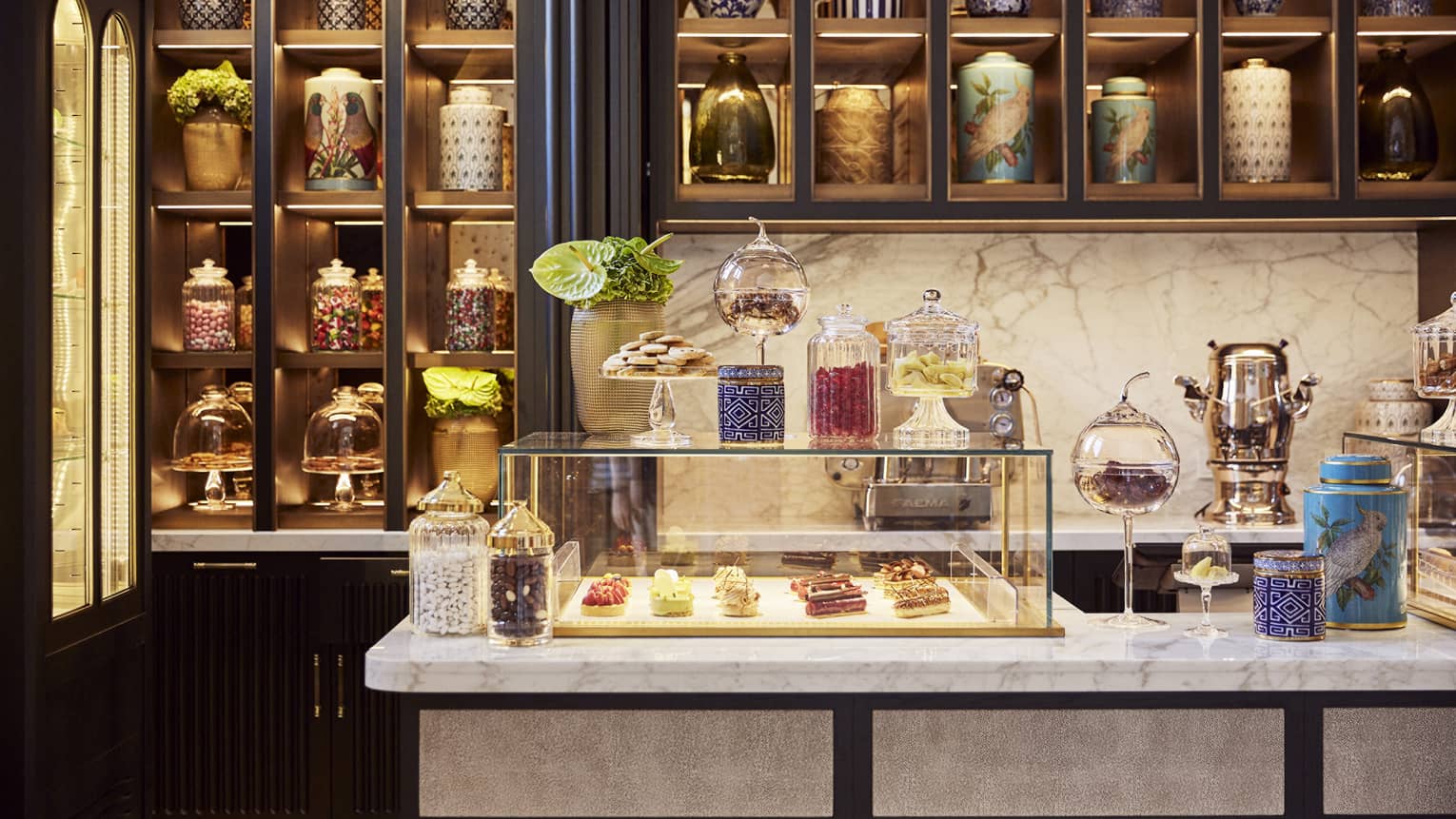 A pastry shop with pastries in a glass case.