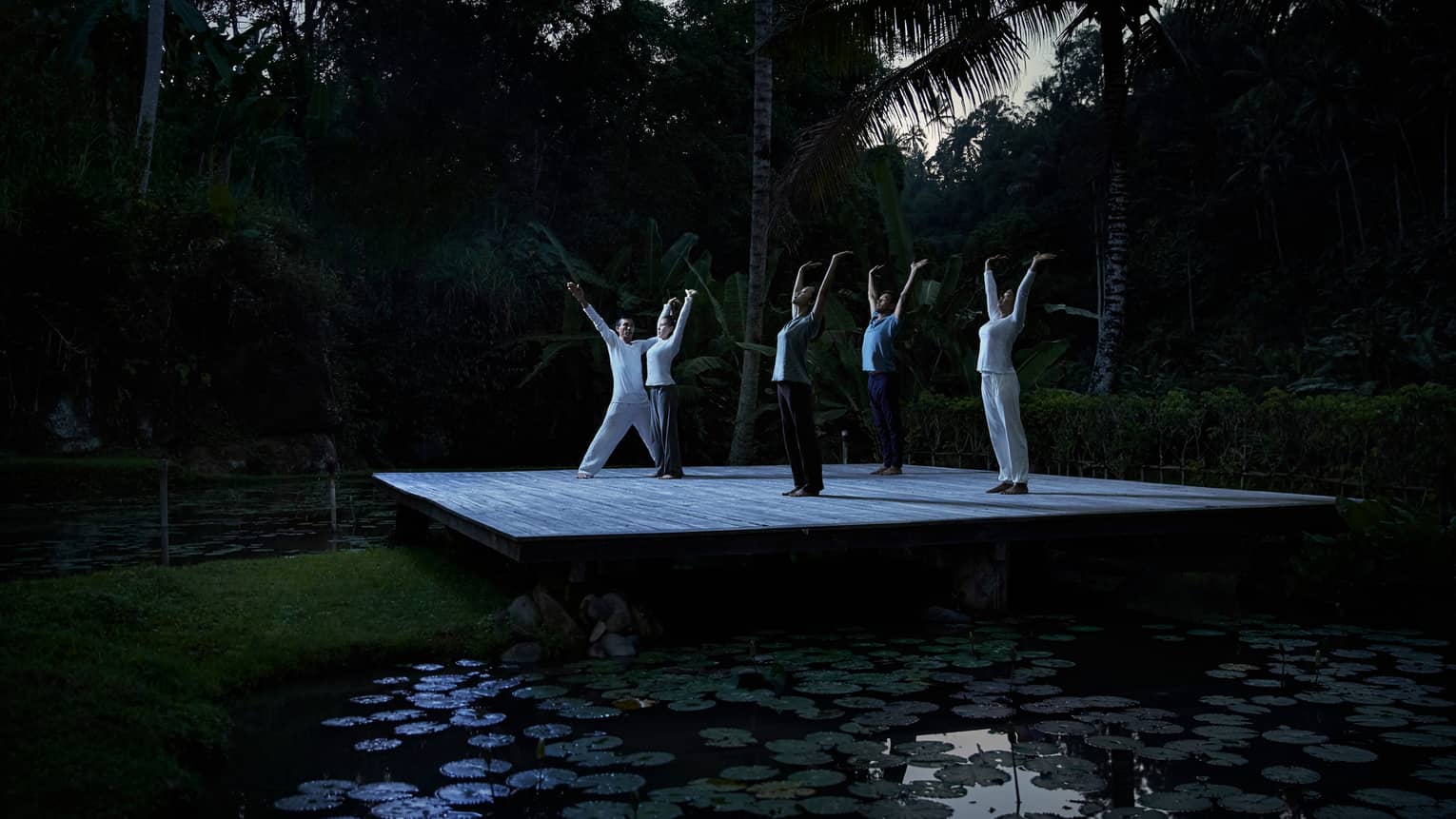 Group full moon purnama yoga near pond in Bali