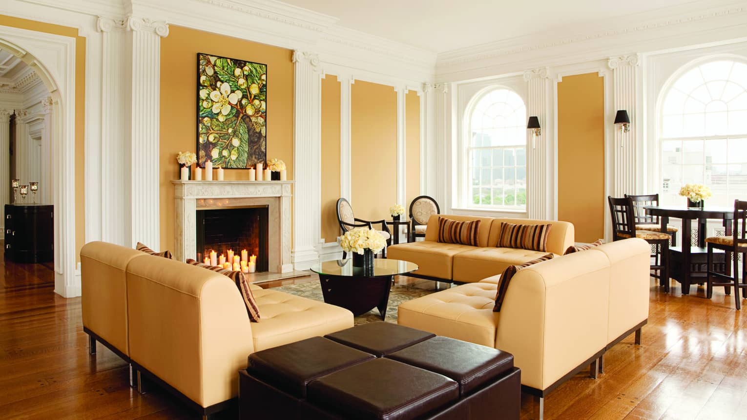 Tan sofas around fireplace in modern Royal Suite Living Room 