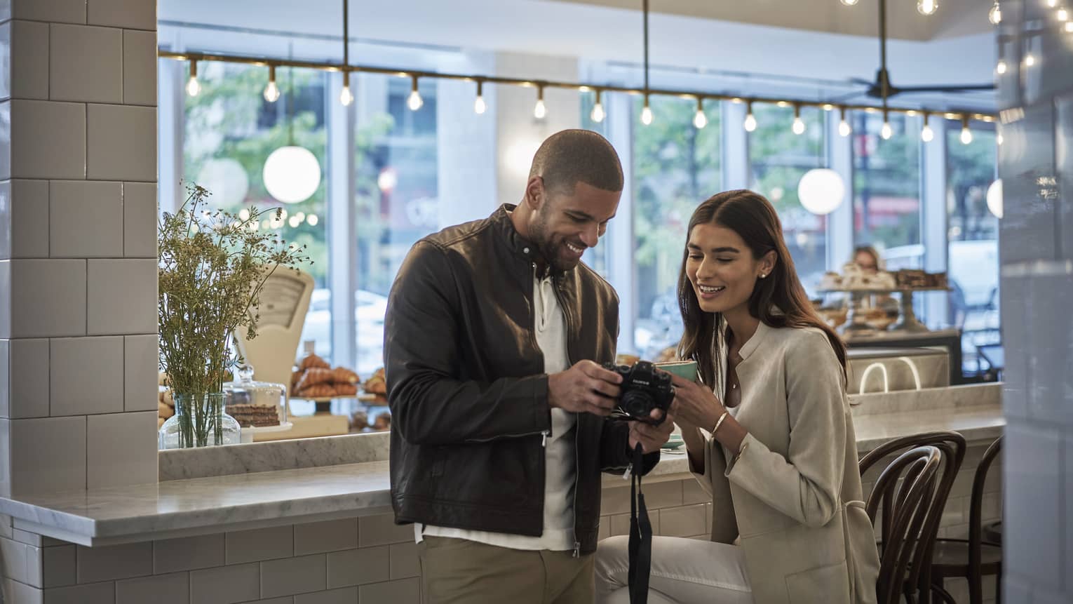 Couple sharing a moment looking at photos on a camera