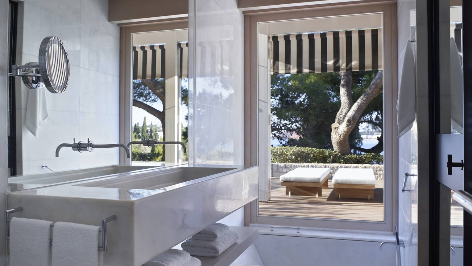 Bungalow Bathroom View with full-width marbled vanity, sink and mirror; floor-to-ceiling window overlooking terrace