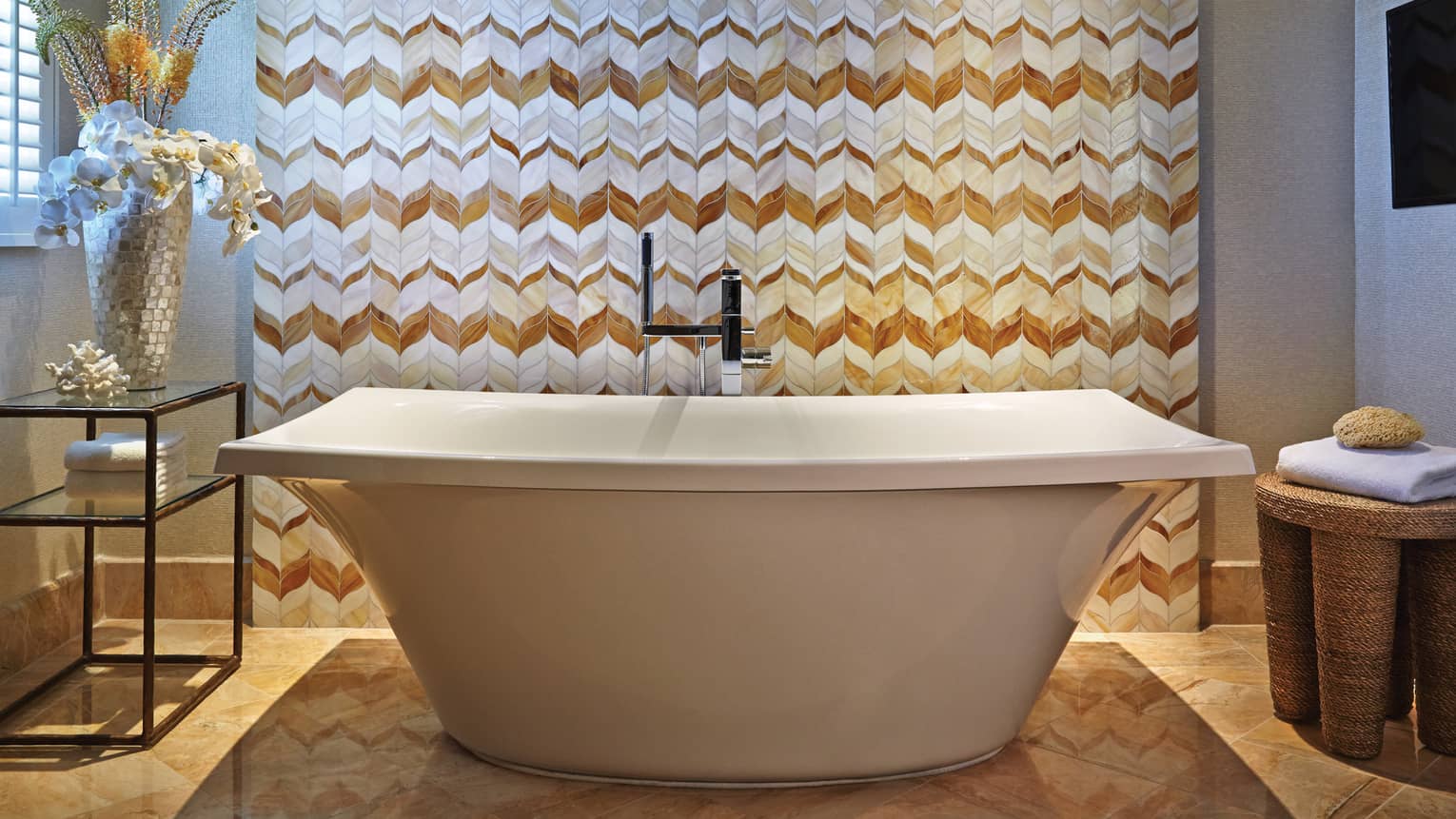 Maile Suite master bathroom with freestanding tub and patterned wall