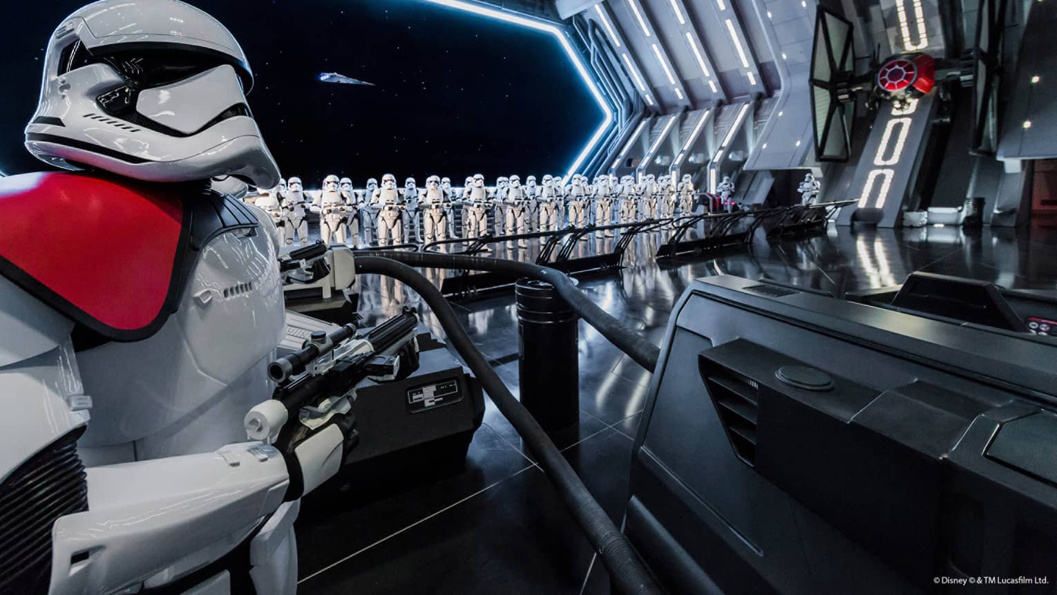A stormtrooper in white armor is standing on the inside of a spaceship.