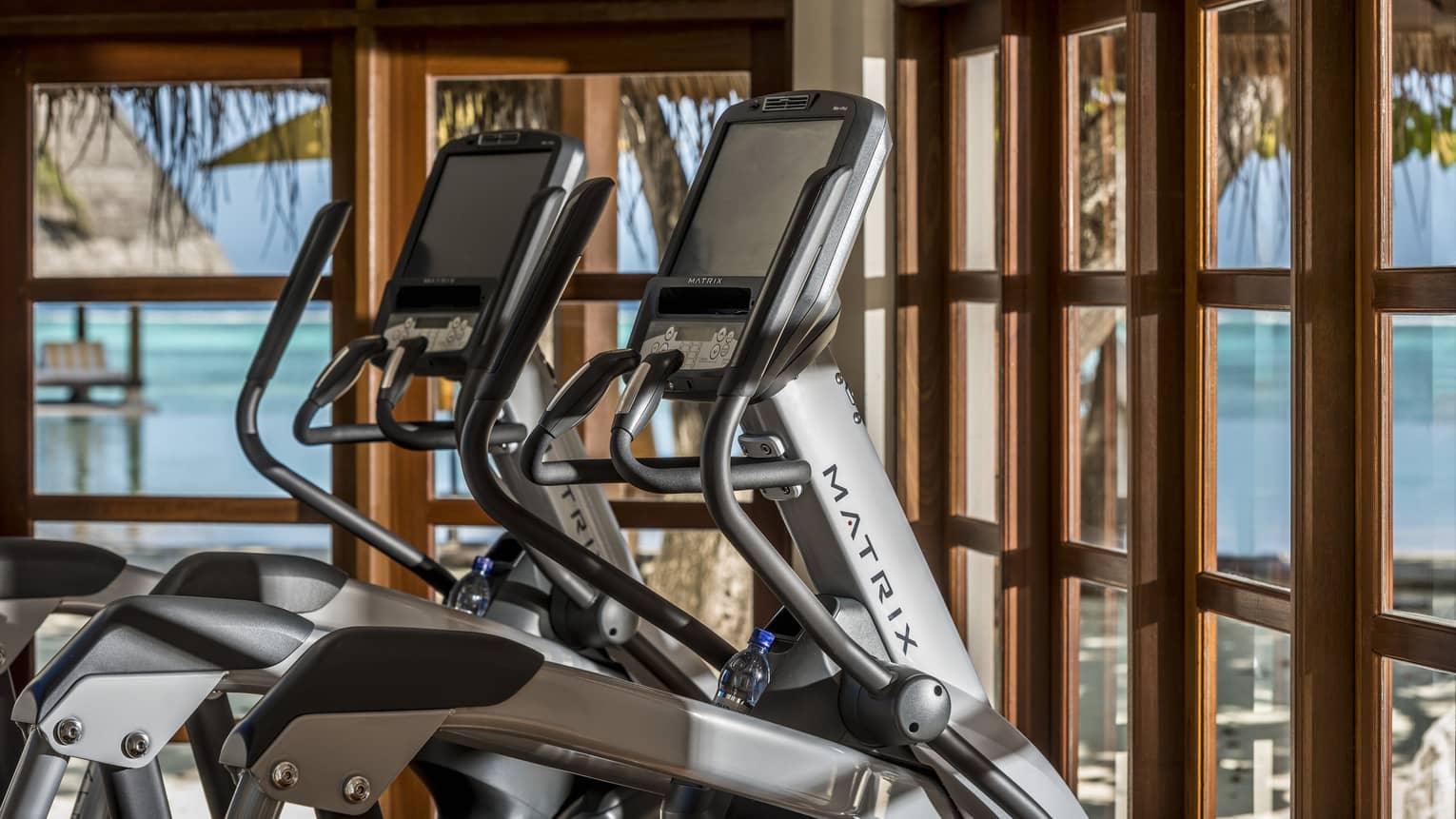 Matrix elliptical machines looking out on the ocean from the fitness centre