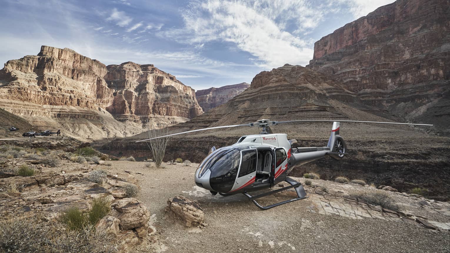 Helicopter sits on rock ledge at Grand Canyon