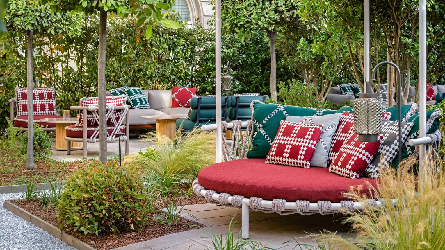 Garden courtyard with red, round covered seating and red-green decor