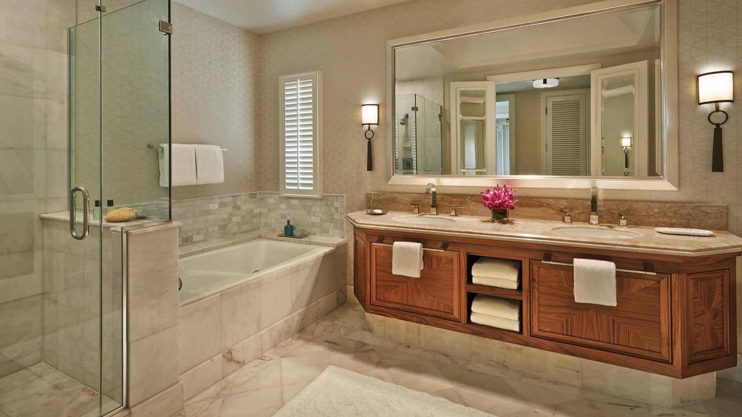 Maile Suite bathroom with double vanity, tub and shower and fresh flowers on the counter