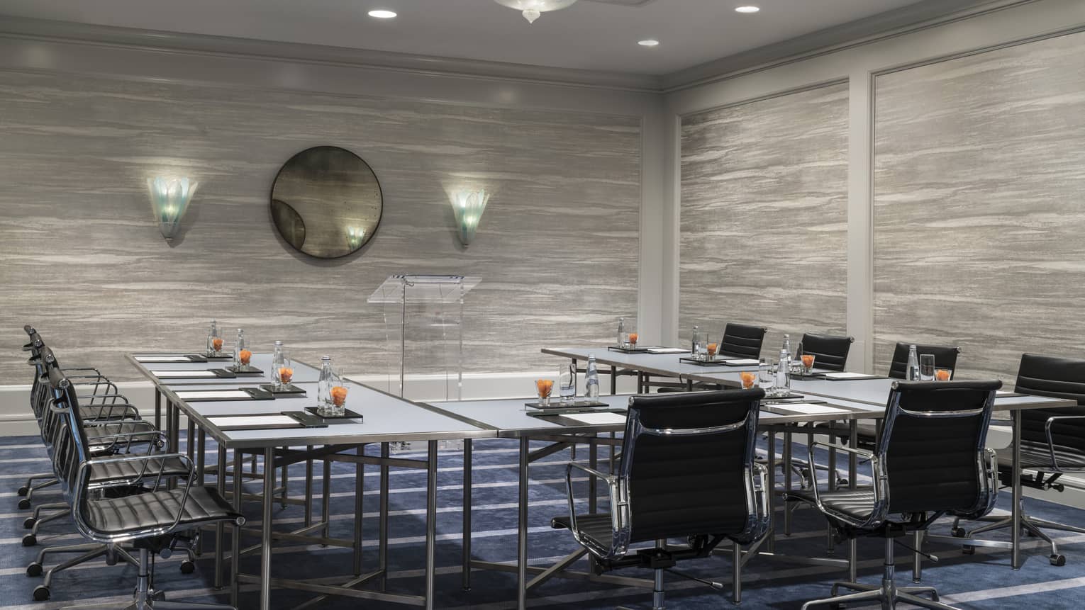 Presidio Suite meeting room with modular tables around glass podium