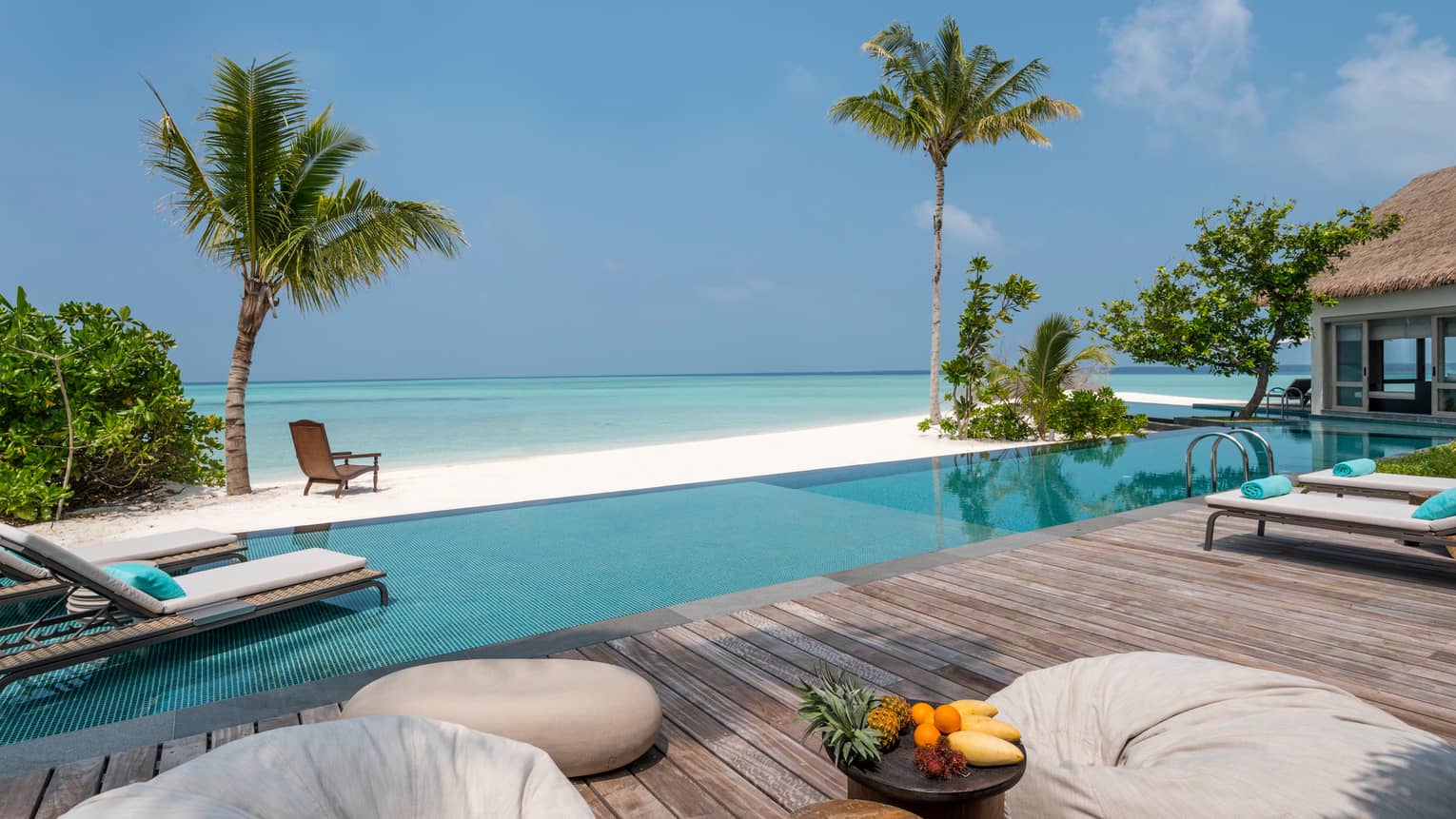 Three-Bedroom Beach Villa fresh fruit on platter on deck by swimming pool, beach