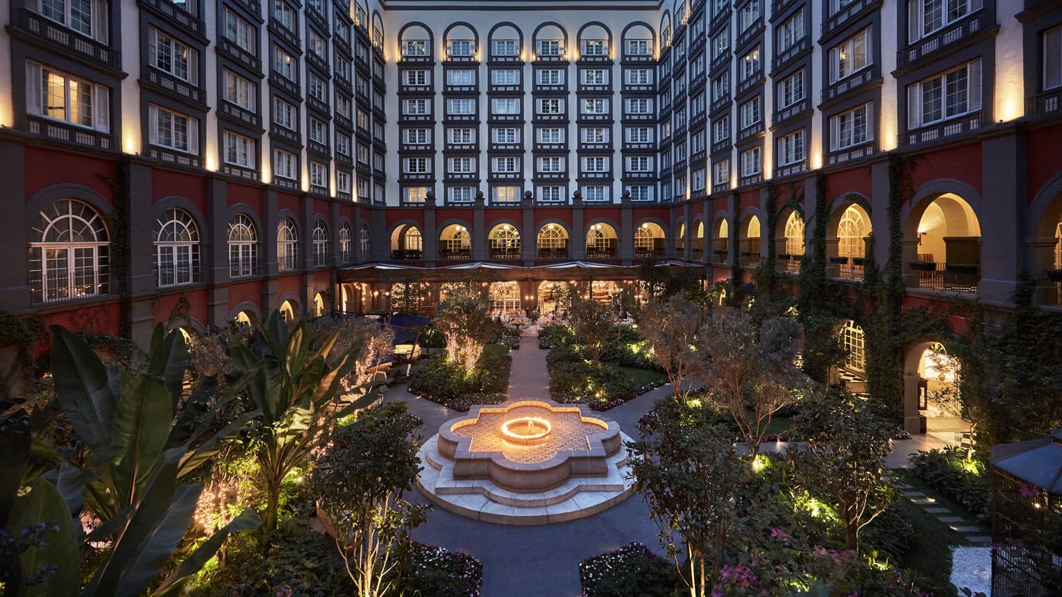 Inner courtyard garden below Four Seasons Hotel Mexico City with lights at night