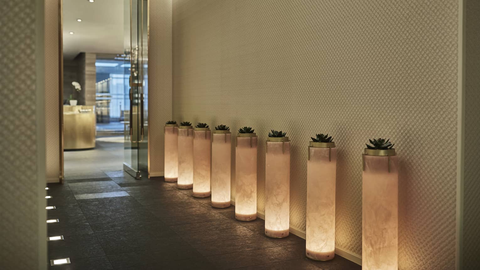 A series of light pillars leading the way to the Four Seasons Toronto lobby.