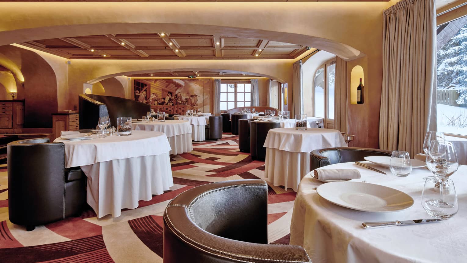 Prima Restaurant, curved leather lounge chairs, dining tables with white linens 
