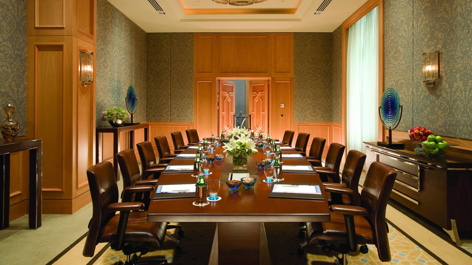 Yenikoy Meeting Room with large brown boardroom table and leather swivel chairs, wood accent walls