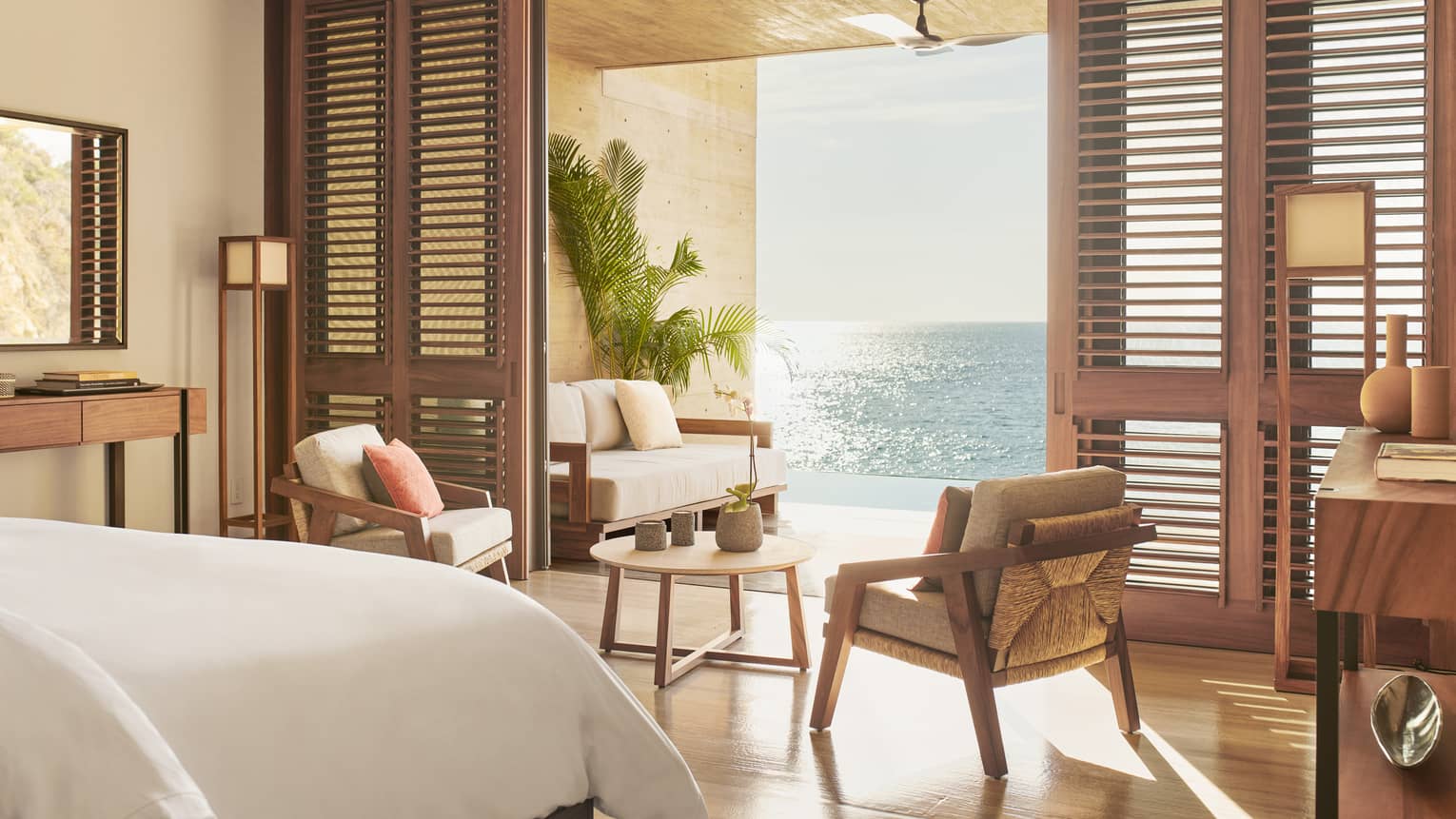 Resort bedroom opening to ocean-view terrace