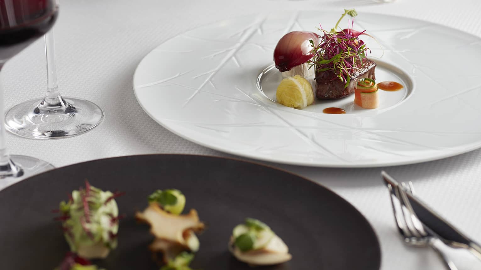 Private dining table, gourmet steak and vegetables on white plate