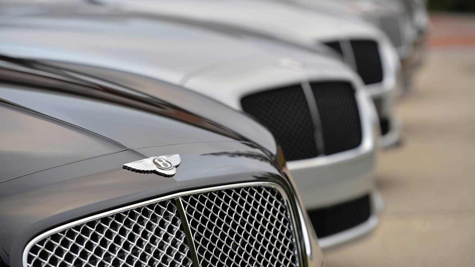 Close up of Bentley car, as part of line up of luxury cars 