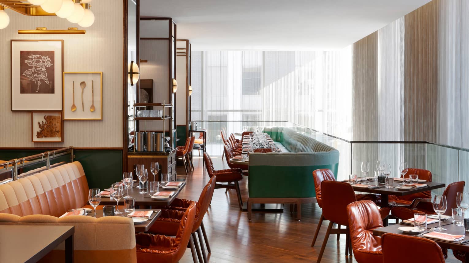 Café Boulud sunny dining room with leather seats and banquettes. tables, white curtains