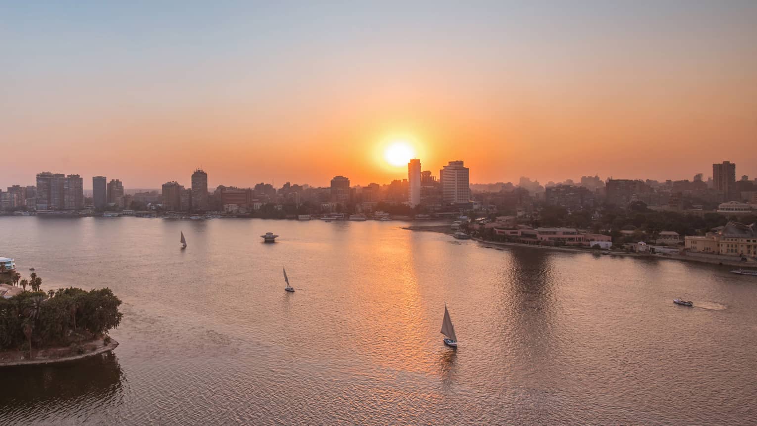 Sunset over Nile River with sailboats in Cairo, Egypt