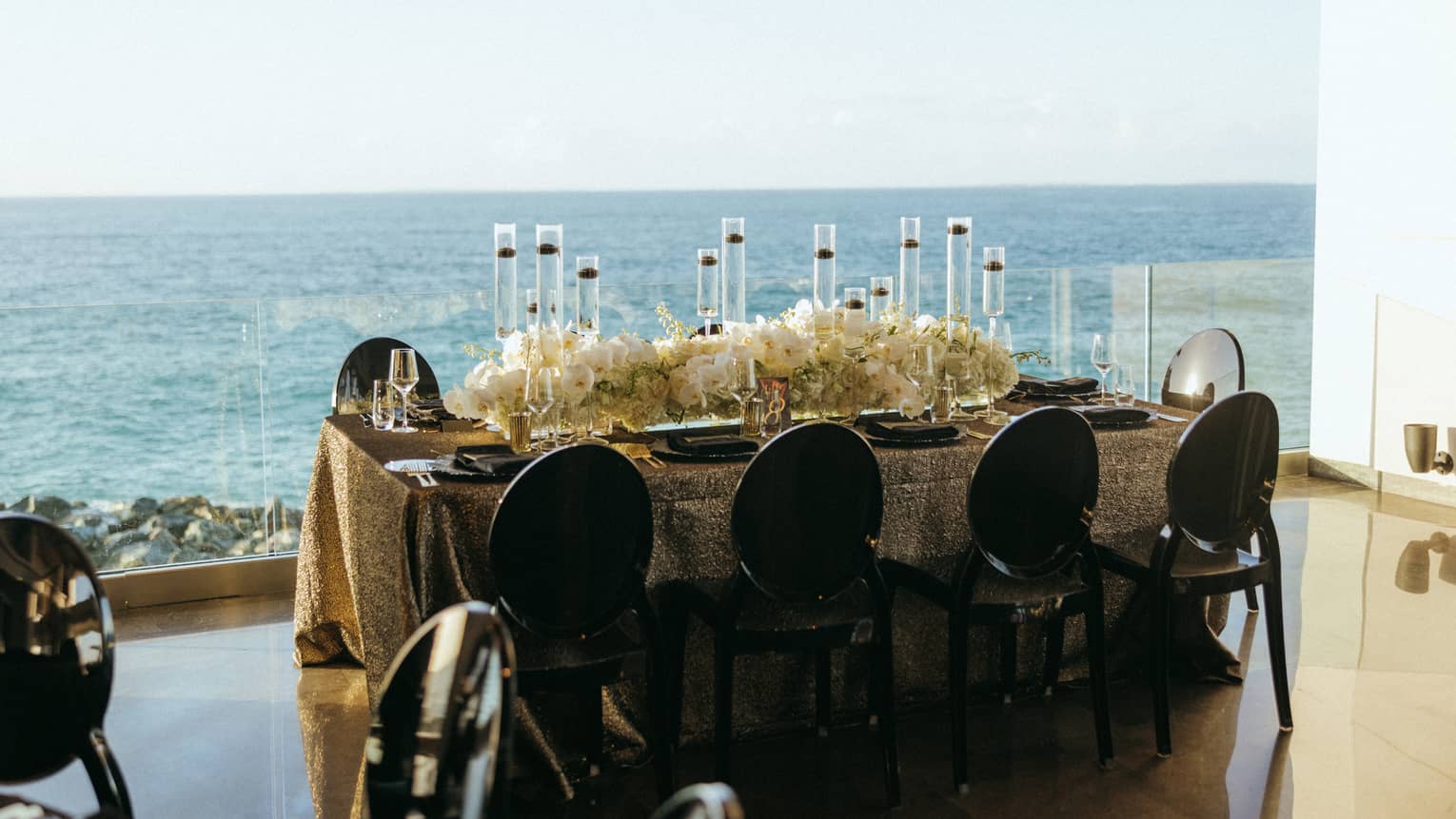 A dining table looking out at the ocean.