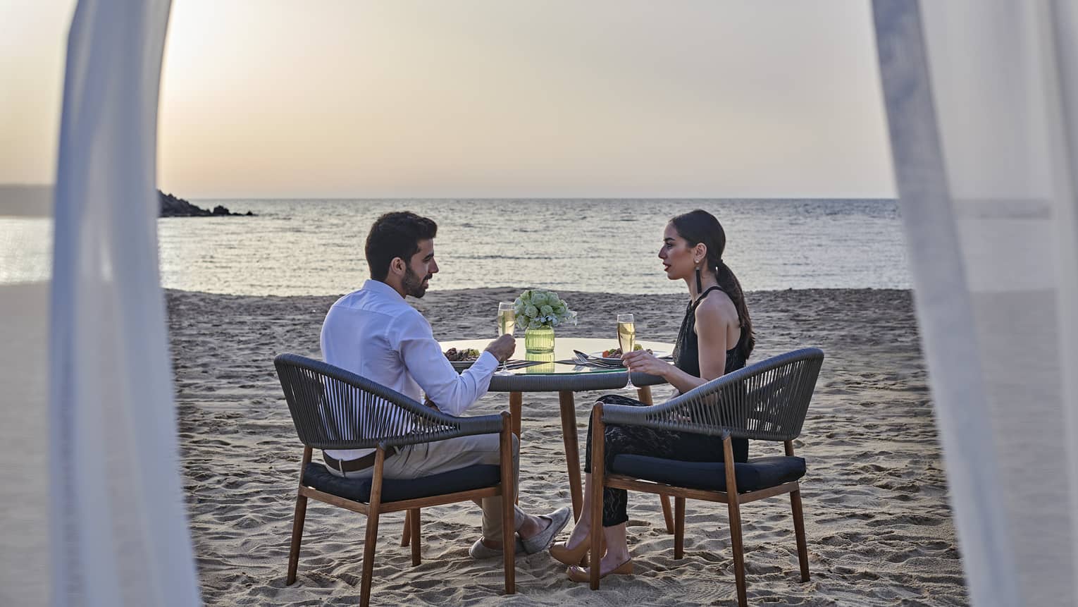 A couple has a romantic dinner for two on the beach at four seasons alexandria