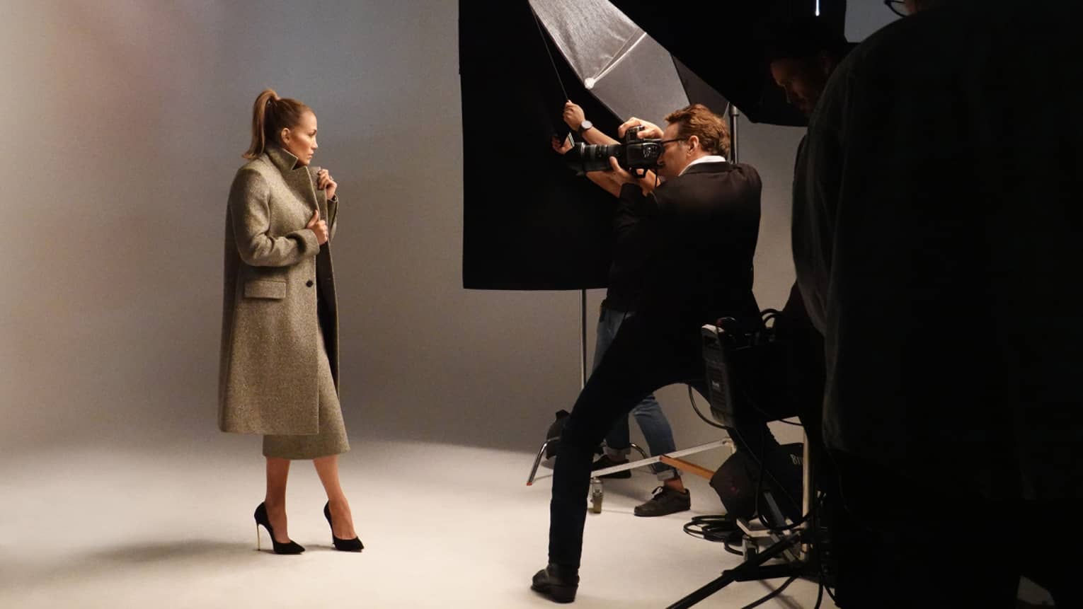 A woman in a coat in a photoshoot.