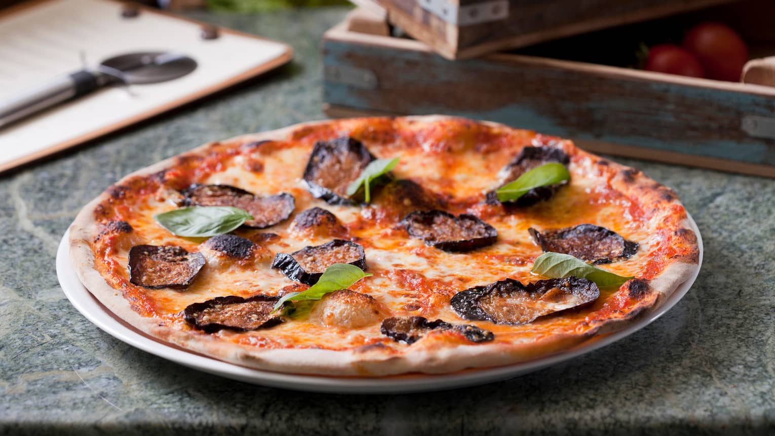 Crispy, thin-crust wood-fired pizza on plate