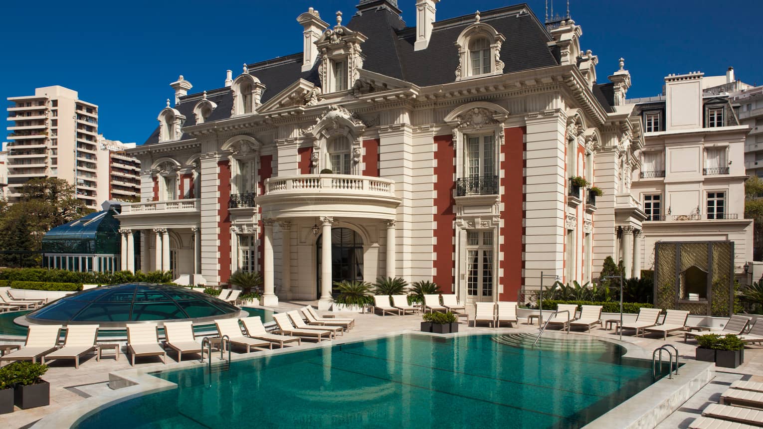 Exterior view of Four Seasons Buenos Aires hotel in historic white mansion with swimming pool