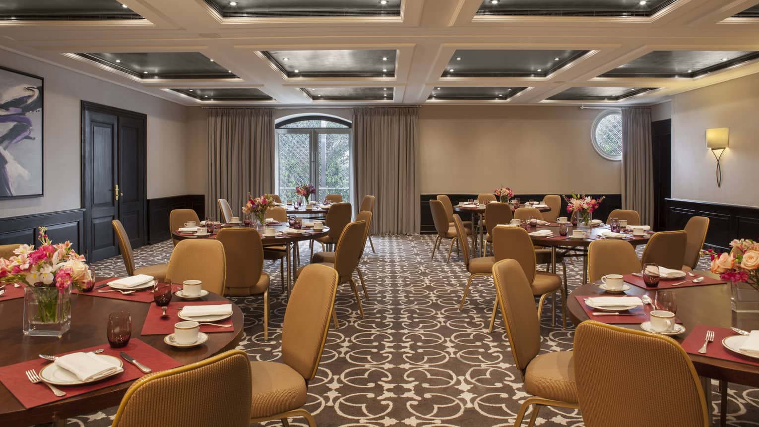 Blas Meeting Room round tables with tan chairs, panel ceiling