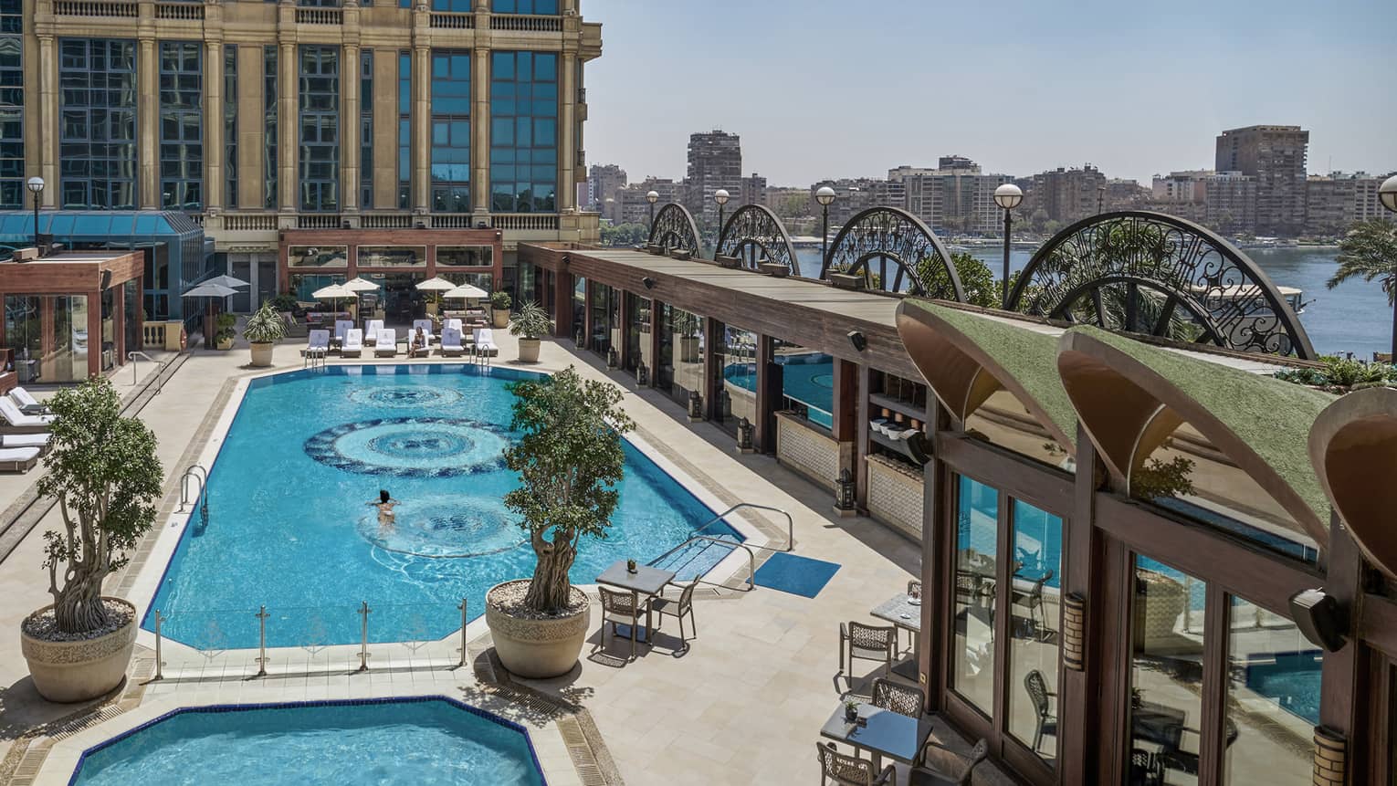 An art deco-inspired courtyard pool boasting stunning ocean and city views