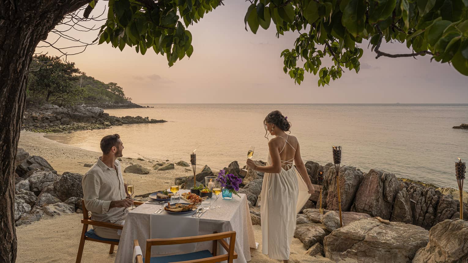 Couple enjoys oceanside sunset dinner