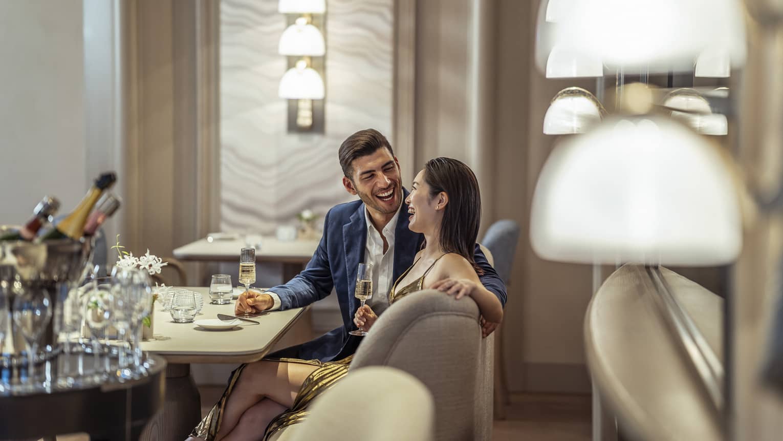 Laughing couple enjoys a romantic meal at S�ZANNE