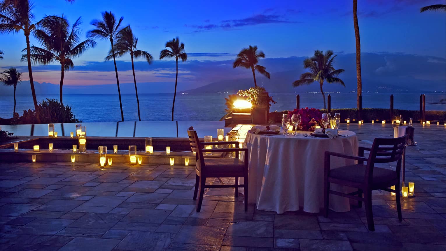 An outdoor candlelit dinner by the seaside in Maui