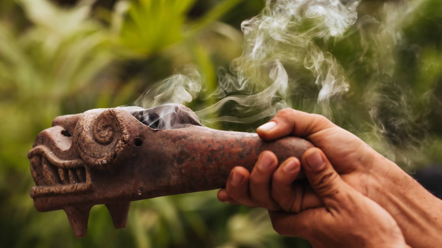 Smoke emerges from traditional Mayan copal pipe