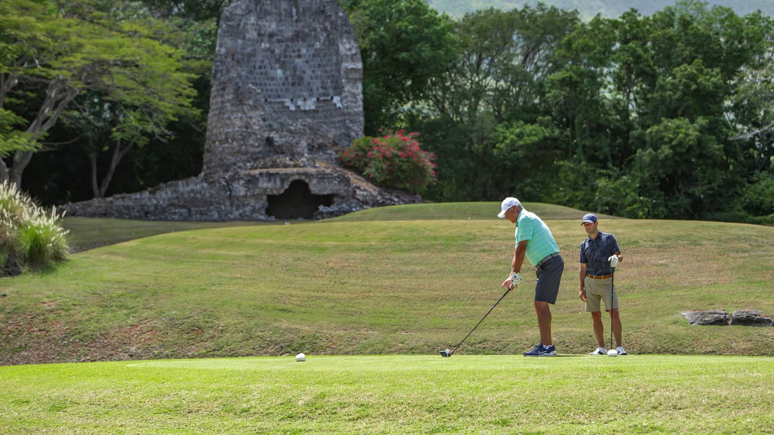 Two men playing golf.