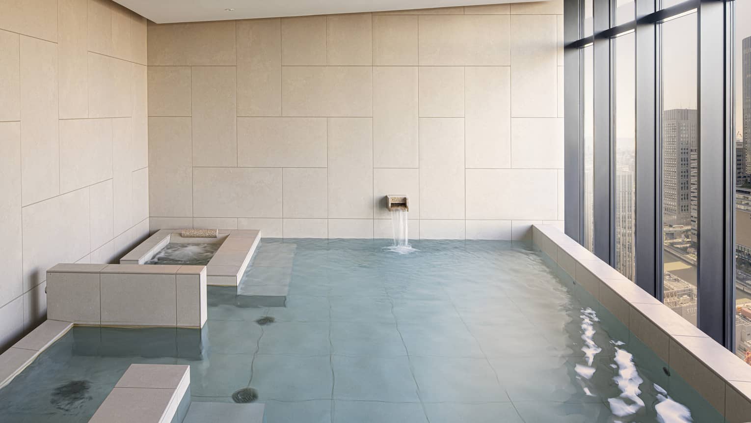 Four Seasons Hotel Osaka Japanese ofuro tub with wall of windows looking out to Osaka city