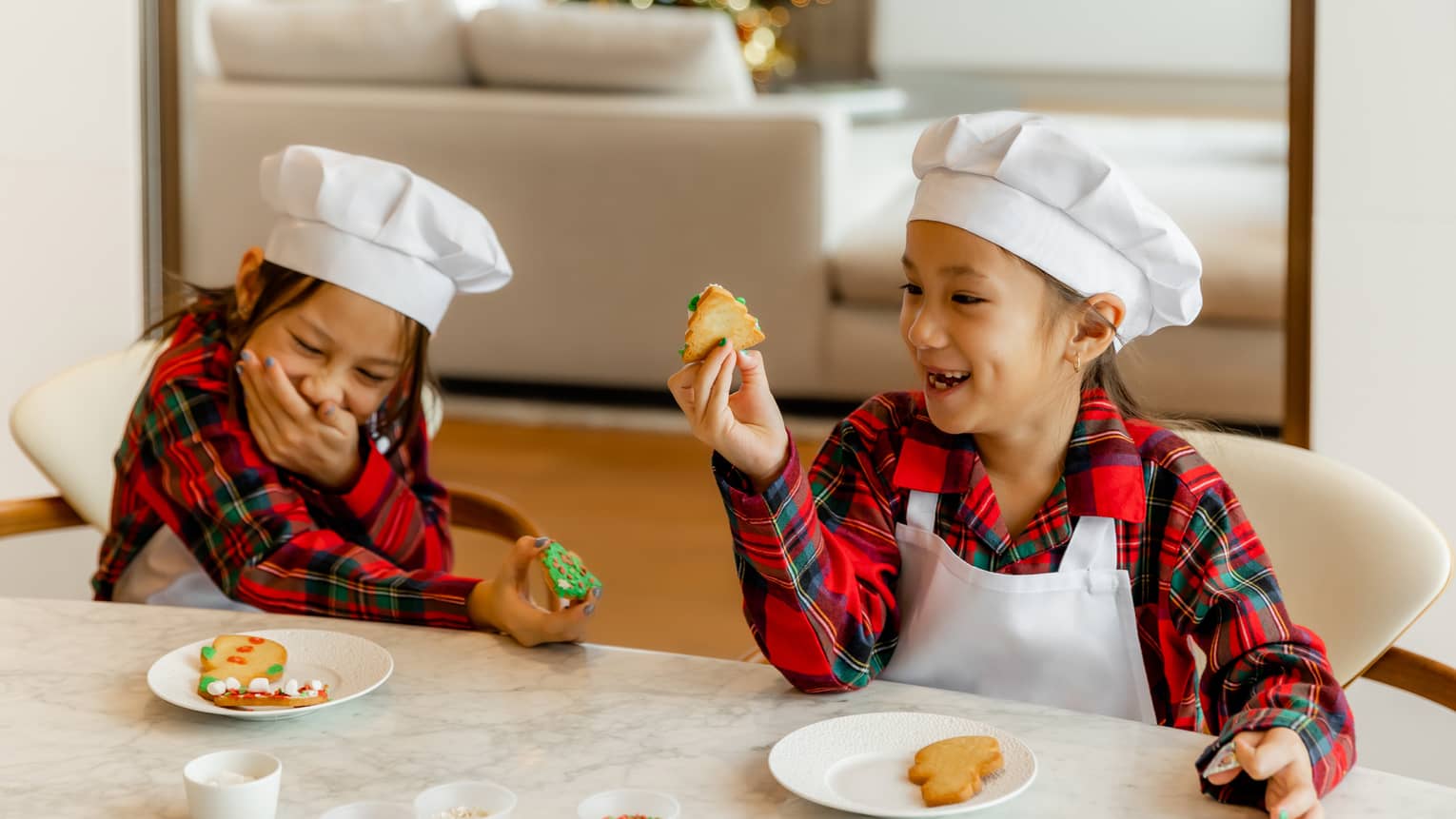 Two young children making cookies.
