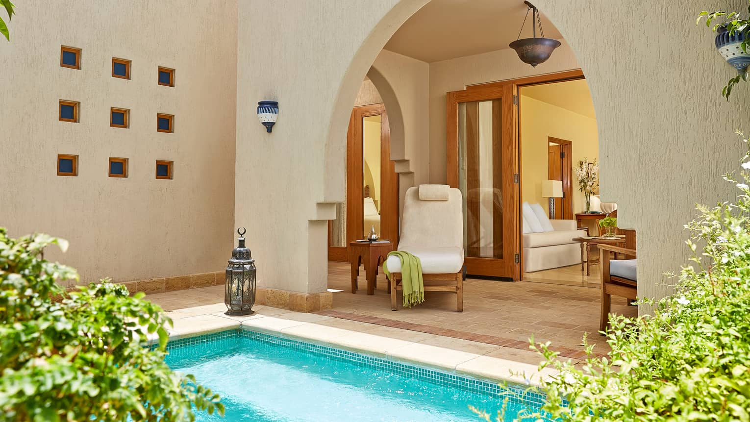 One-Bedroom Suite With Plunge Pool, plush pool chair by corner of turquoise swimming pool