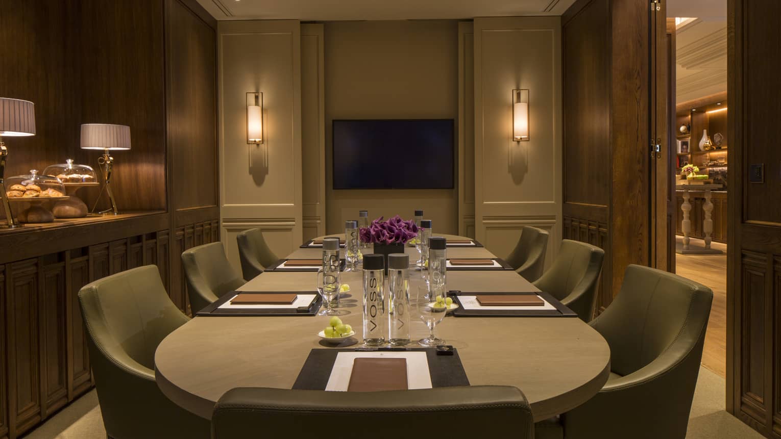Ariel Meeting Room, large round boardroom table and modern chairs, low lighting