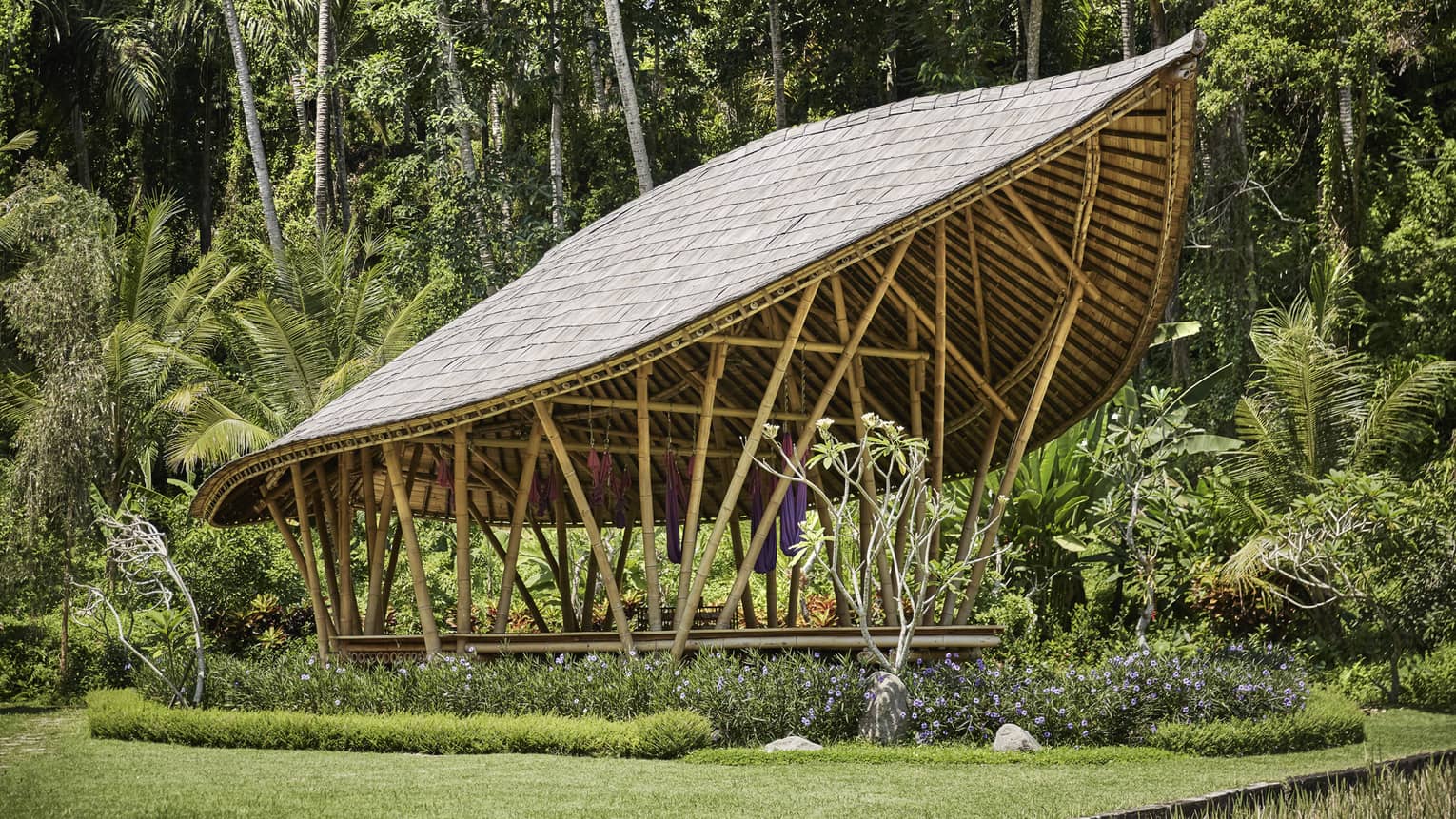 Dharma Shanti Bale leaf-shaped pavilion in tropical garden