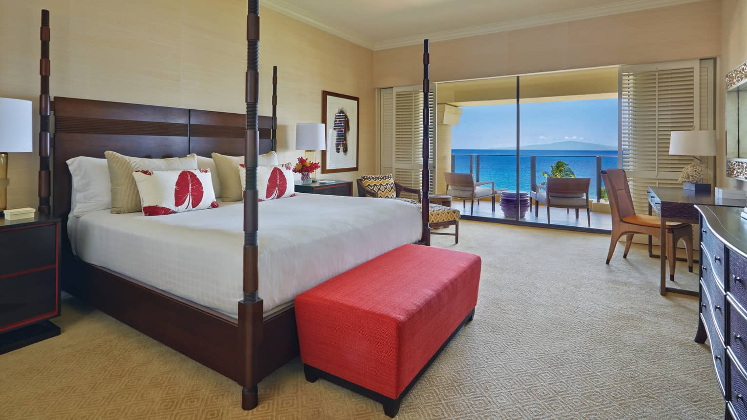 Maile Suite king bedroom with four poster bed and view of the ocean from a private terrace