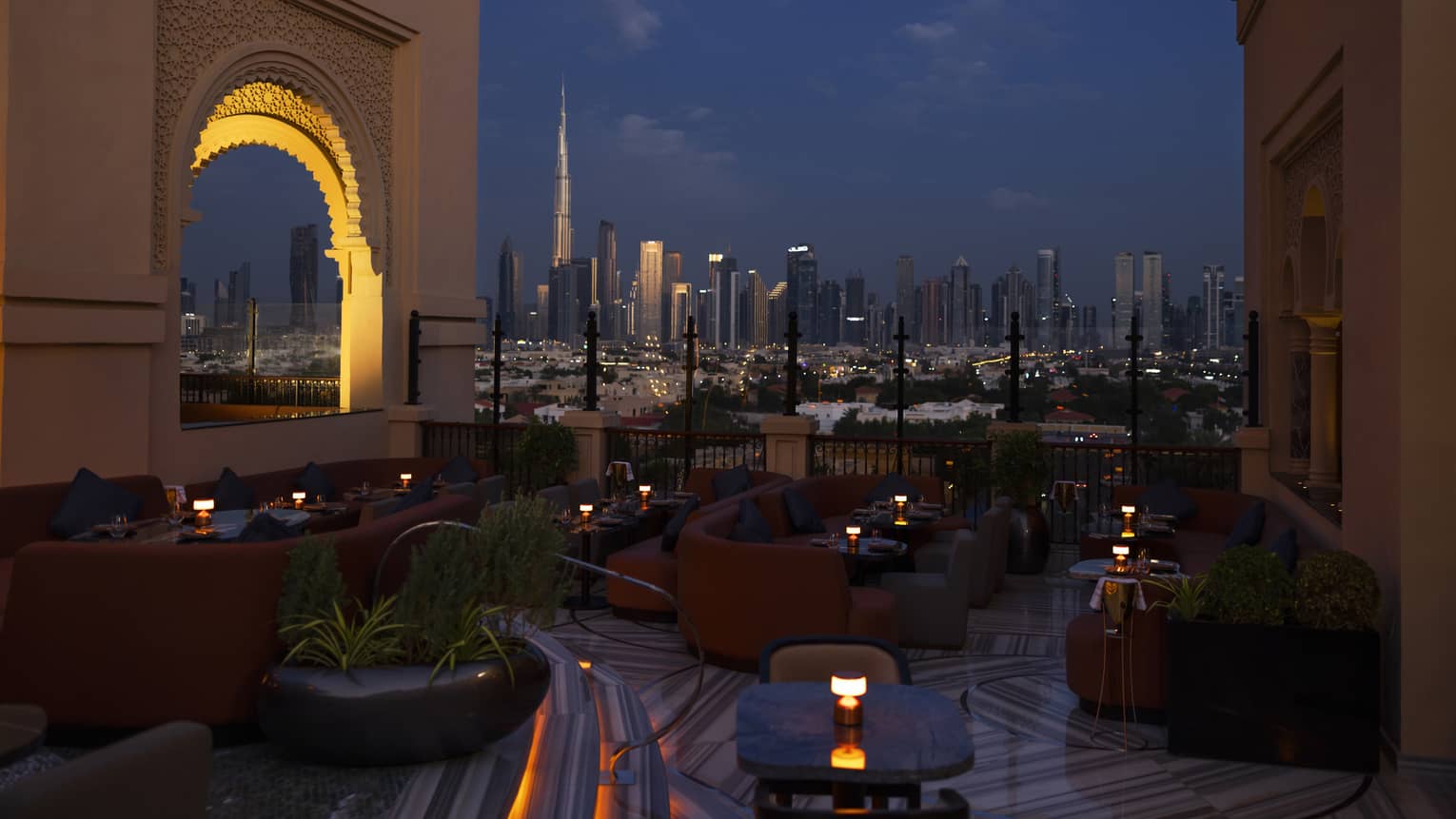 Nightime view of rooftop lounge overlooking the Dubai skyline