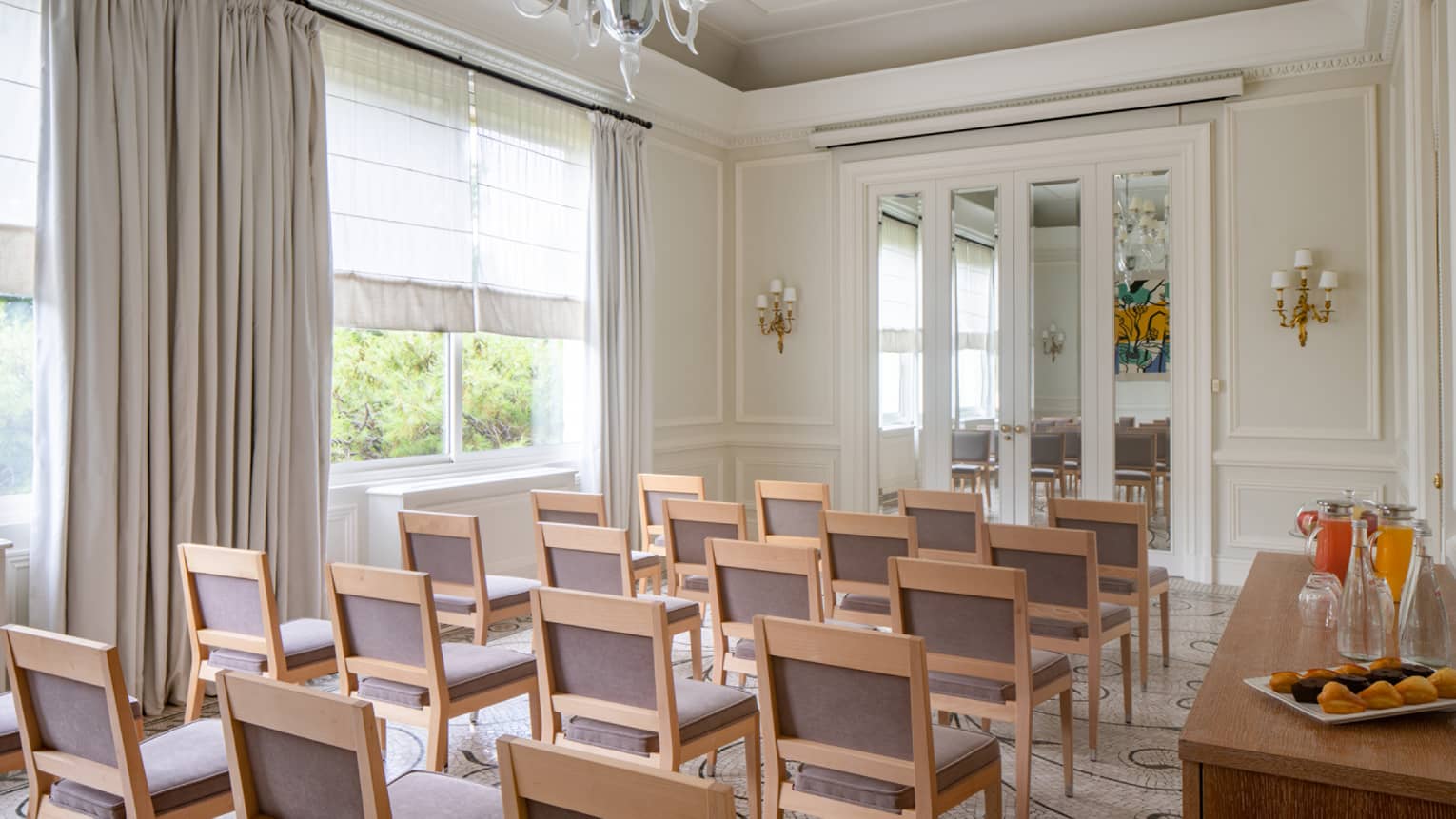 Salon Les Pins with classroom seating, curtained window, chandelier, French doors